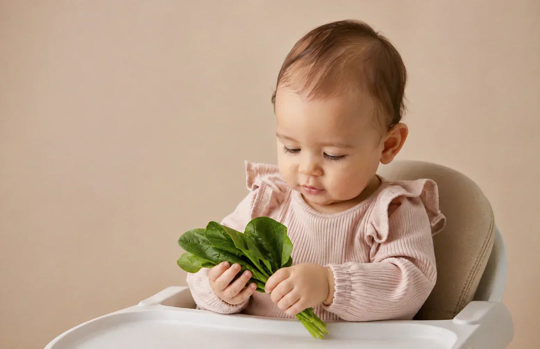 Baby exploring spinach